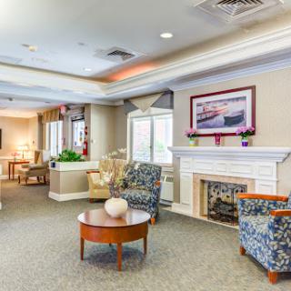 A cozy living area featuring comfortable seating and a decorative fireplace.