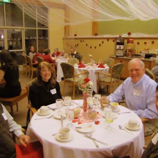 A group of people enjoying a festive dinner at a decorated table.