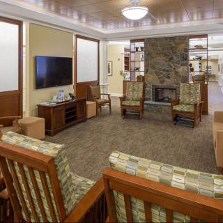 A cozy living room with a fireplace, TV, and comfortable seating arrangement.