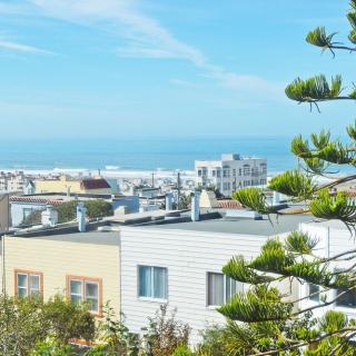 Scenic view of coastal rooftops with the ocean in the background.