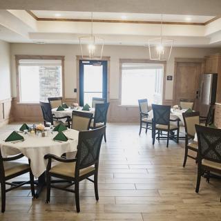 An elegantly designed dining area with multiple tables set for guests.