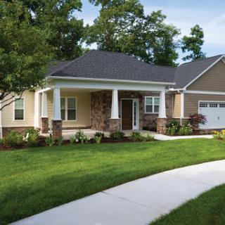 A beautiful residential home showcasing a well-maintained front yard and modern architecture.