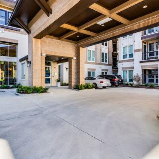 A modern apartment complex with a covered driveway entrance.