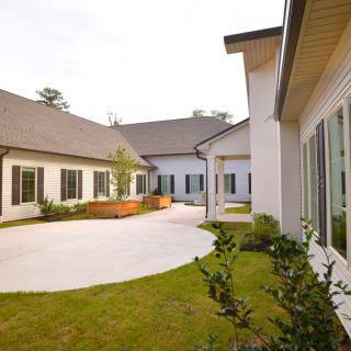 A modern house with a spacious courtyard and landscaped garden area.
