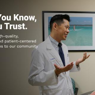 A healthcare professional engaging with patients, emphasizing quality and trust in community care.