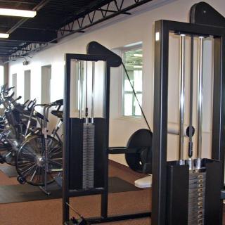 A modern gym with various exercise machines and equipment.