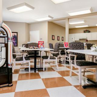 Retro diner interior with checkered floor tiles and a classic jukebox.