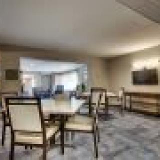 A modern dining room with a large table and chairs, emphasizing minimalistic interior design.