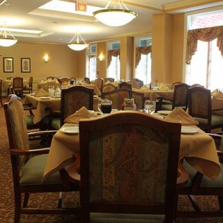 An elegant dining area with neatly arranged tables and chairs.