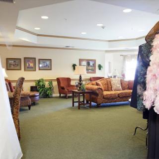 A cozy lounge area featuring comfortable seating and a clothing display.