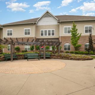 A welcoming residential building featuring a landscaped outdoor area with seating.