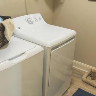 A laundry room with a washer and dryer side by side.