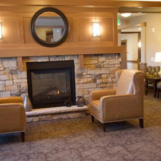 A cozy living room featuring a warm fireplace and comfortable seating, perfect for relaxation.