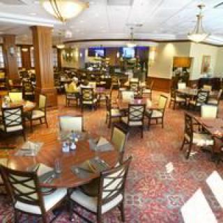 An interior view of an empty restaurant dining area with neatly arranged tables and chairs.