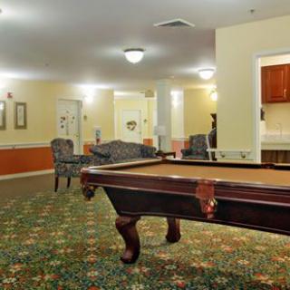 A cozy recreation room featuring a pool table and seating area.