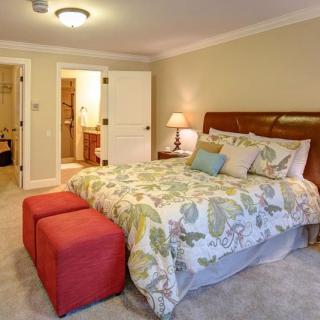 A cozy bedroom with a floral bedspread and warm lighting.