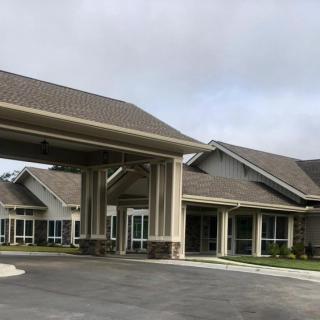 Exterior view of a modern building with a covered entrance and driveway.