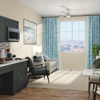 A modern living space with a kitchen, comfortable seating, and large windows with blue curtains.