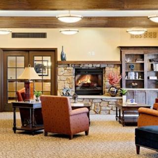 A cozy living room with a fireplace and comfortable seating.