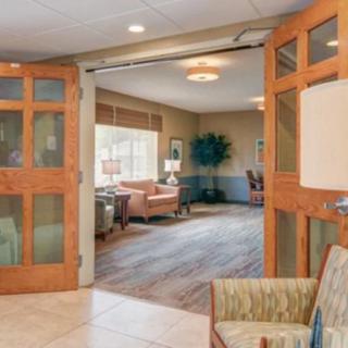 A cozy lobby area with modern decor, featuring comfortable seating and warm lighting.
