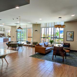 A spacious and modern hotel lobby featuring comfortable seating and ample natural light.
