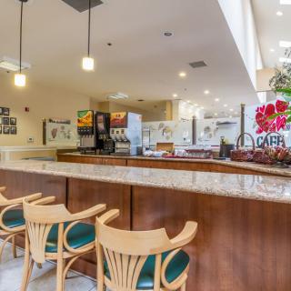 A modern cafe interior with a stylish counter and seating area.