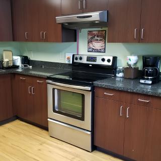 A modern kitchen with stainless steel appliances and wooden cabinets.