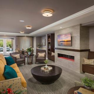 A modern and cozy living room with a fireplace, comfortable seating, and contemporary decor.