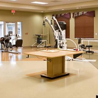 A physical therapy room equipped with various rehabilitation and exercise machines.