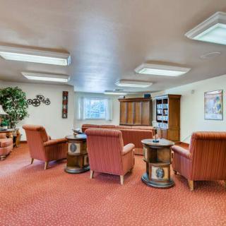 A cozy living room with comfortable seating and warm lighting.