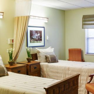 A cozy bedroom with twin beds, decorated in a warm and inviting style.