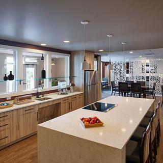 A spacious and modern kitchen with an island and stainless steel appliances.