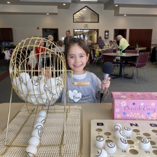 A child enjoys playing bingo in a community center.