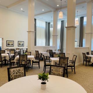 Elegantly furnished dining area with neatly arranged tables and chairs.