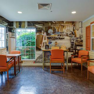 A cozy interior space featuring orange furniture and a decorative wall mural.