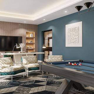 A stylish game room featuring a pool table, modern furniture, and a large TV.