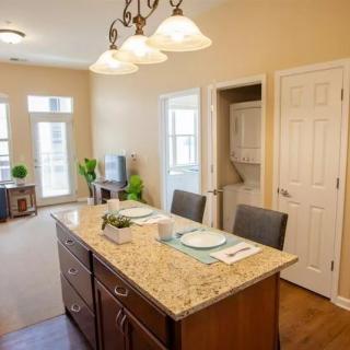 Modern kitchen interior with a central island and elegant lighting.