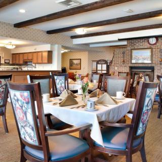 A cozy and elegant dining room with neatly arranged tables and chairs.
