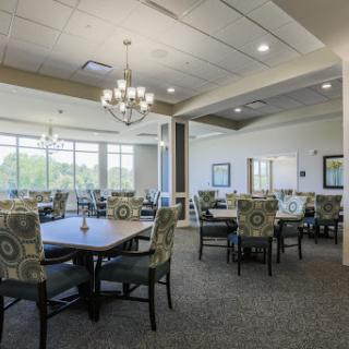 A spacious and modern dining area featuring elegant furniture and ample natural light.