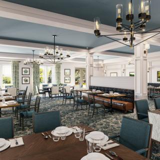 A stylish restaurant interior featuring neatly arranged tables and elegant chandeliers.