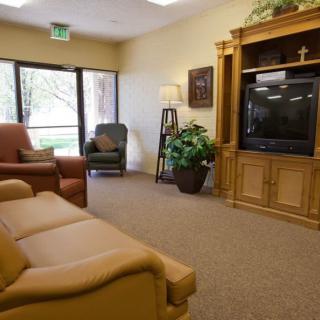A cozy living room with comfortable seating and a large television.