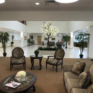 A spacious lobby with seating and decorative plants.