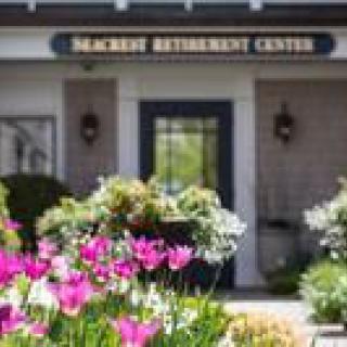 Entrance to Seacrest Retirement Center surrounded by vibrant flowers.
