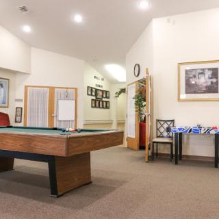 An inviting game room featuring a pool table and cozy decor.