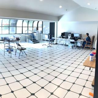Spacious office with tiled flooring and several workstations.