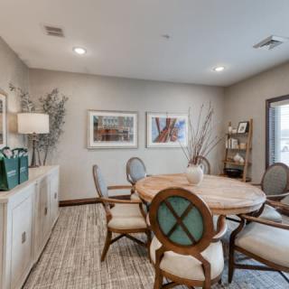 A cozy dining room with elegant furniture and tasteful decor.