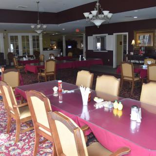 An empty restaurant dining area with arranged tables and chairs.