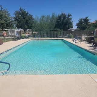 A serene outdoor swimming pool under a clear blue sky, perfect for relaxation.