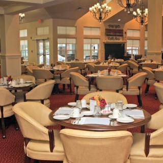 A beautifully designed dining area featuring elegant furniture and soft lighting.