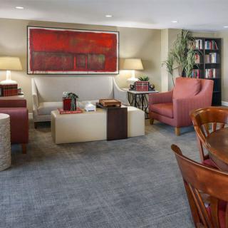 A cozy living room with stylish furniture and modern artwork.